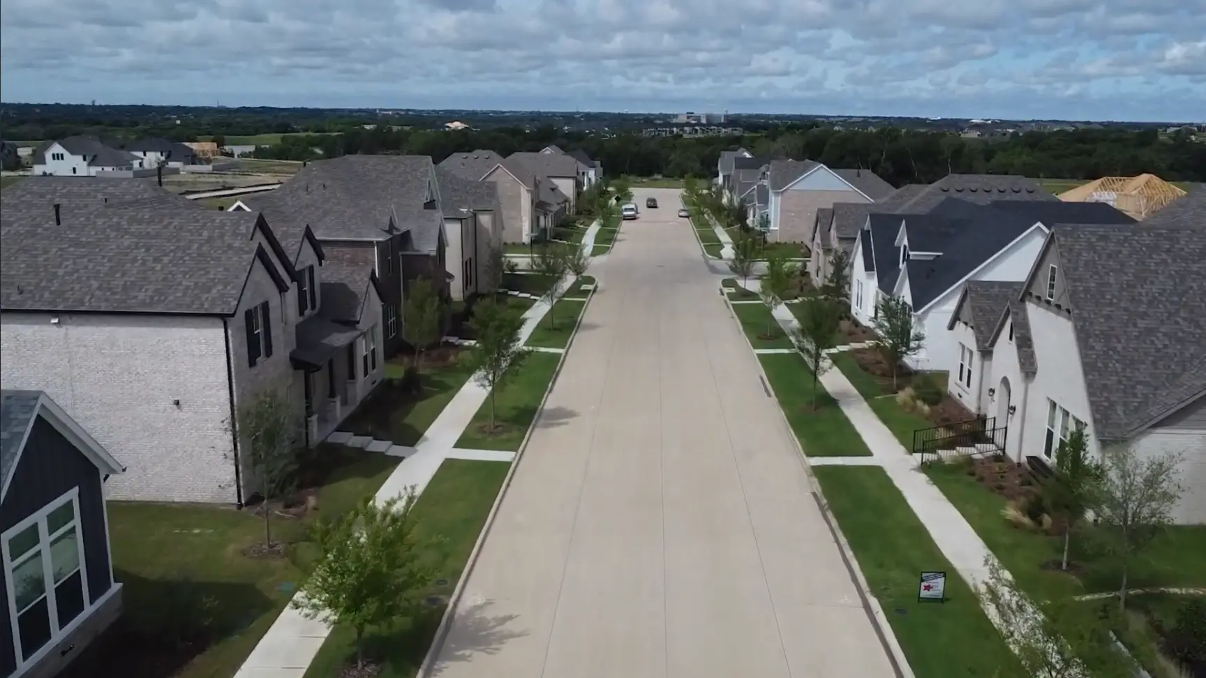 Completed residential street with new homes in Painted Tree McKinney TX