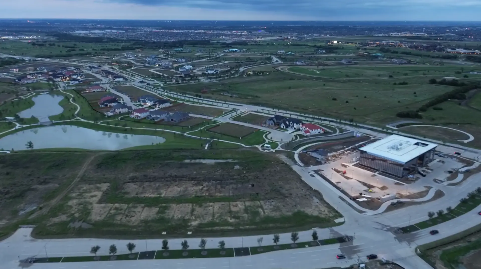 Aerial view of residential streets, lakes and new homes inside Fields in Frisco, Texas