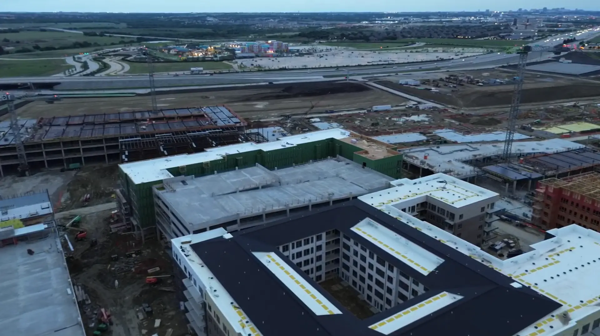 Wide aerial view of active construction across the Fields West urban village