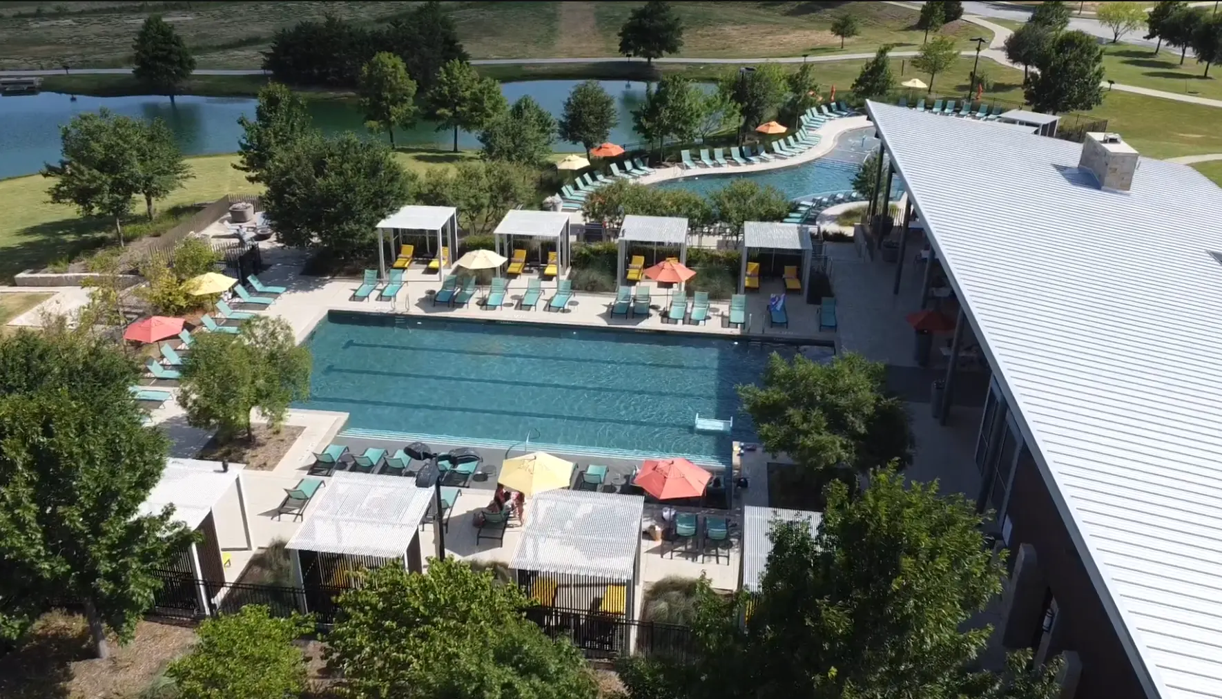 Aerial view of the Windsong Ranch amenity center pool, cabanas and pond in Prosper, TX
