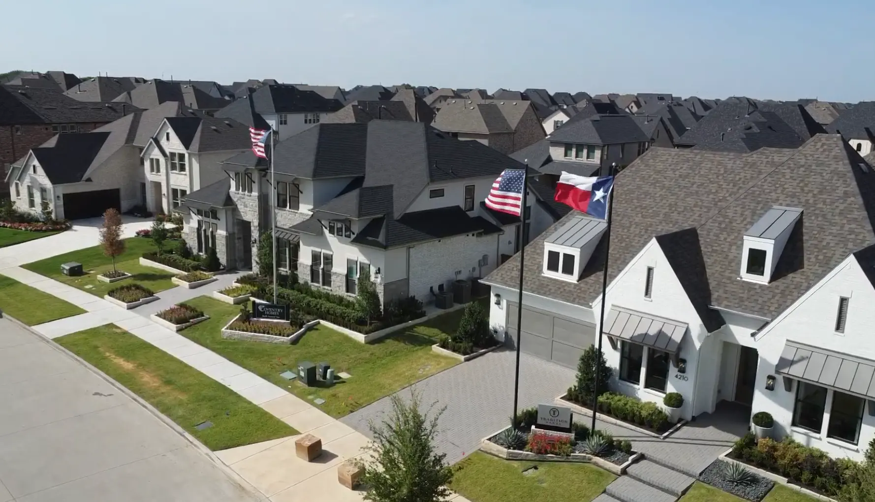 Model homes in Windsong Ranch Prosper TX with builder signs and flags