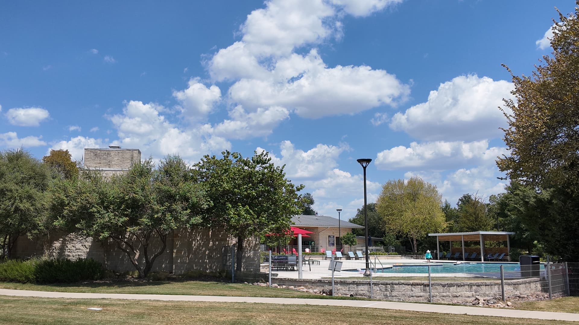 Trinity Falls resort-style community pool with shade structures and lounge chairs