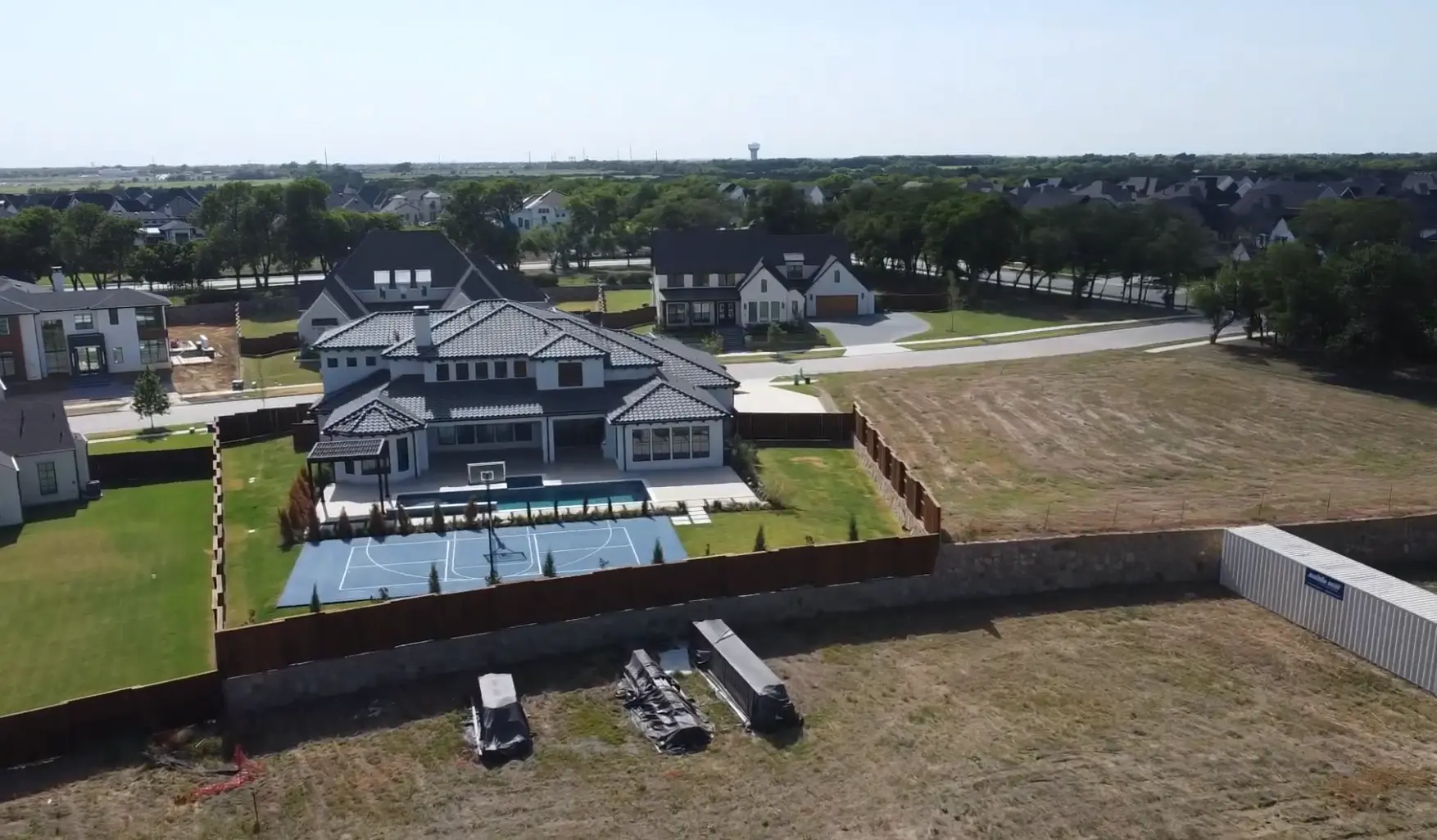 Aerial of a large Windsong Ranch home with private pool and sport court