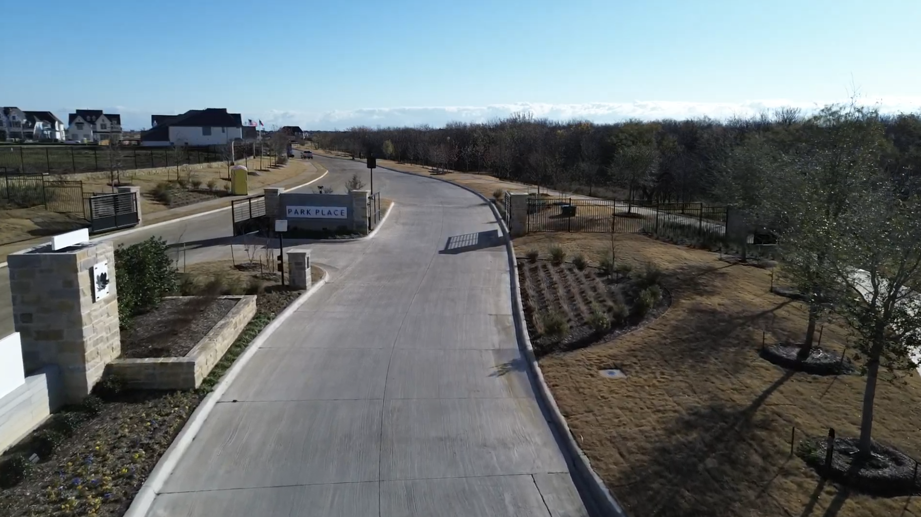 Aerial view of the Park Place gated entrance and community entrance road in Prosper, Texas